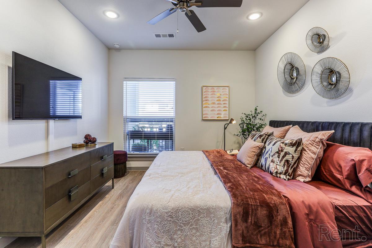 Second bedroom staged with a queen bed
