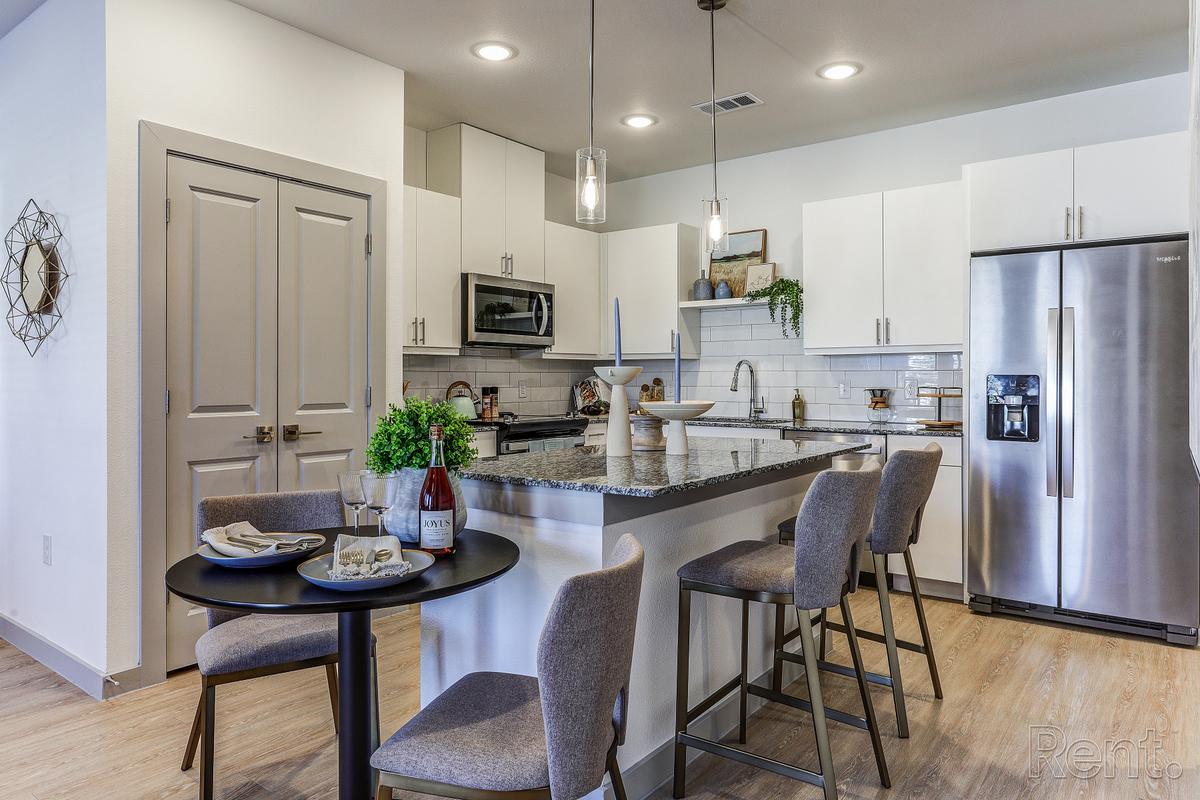 Open kitchen with granite counter tops beside the dining area